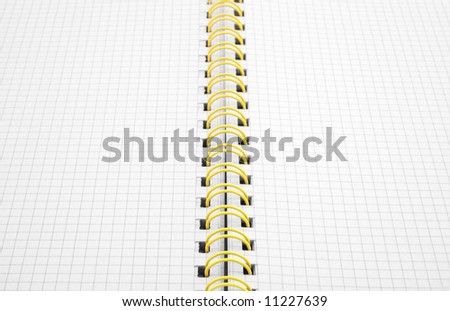 Close up of a spiral bound notebook with yellow spirals