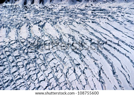 Aerial View of the Crumpled Ice Field of an Alaskan Glacier in the Great Alaskan Wilderness, Denali National Park, Alaska.  A Beautiful Snowscape of Rock, Snow, and Ice.