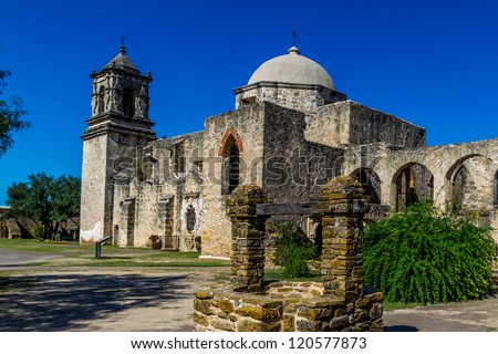 The Historic Old West Spanish Mission San Jose, Founded in 1720, San Antonio, Texas, USA.  Showing dome, bell tower, and one of the old stone water wells.