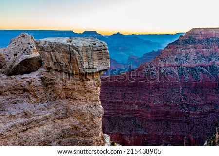 An Interesting Boulder Capped Ledge at the Magnificent Multi-colored Grand Canyon in Arizona.  Early morning.
