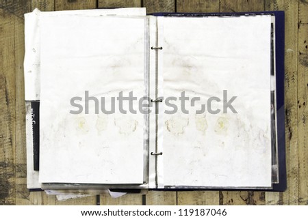 Stack of old paper document album on old grunge wood background