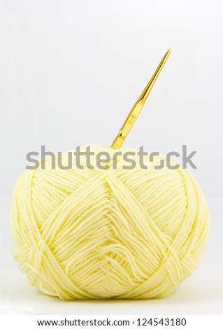 Yellow ball of wool and knitting needles isolated on white background