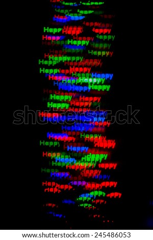 Festive winter happy  word made from lights bokeh background