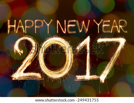 Happy new year 2017 word made from sparkler light firework on bokeh background