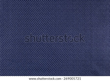 White dots over blue Polka dot fabric background and texture