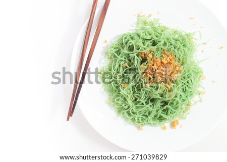 Green noodles with braised leeks on white background