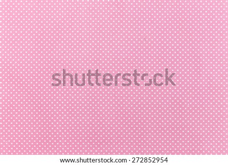 White dot over pink fabric background and texture