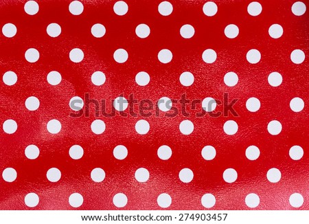 White dots over red Polka dot fabric background and texture
