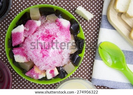 A favorite dessert in summer. Shaved ice with red soda, bread and black jelly.