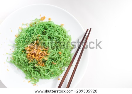 A dish of Green Noodle with braised leeks on white background
