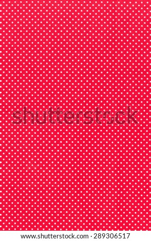 Seamless White dots over red Polka dot fabric background and texture