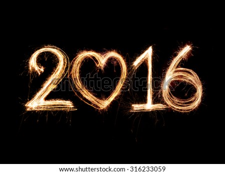 2016 word written with Sparkle firework on black background