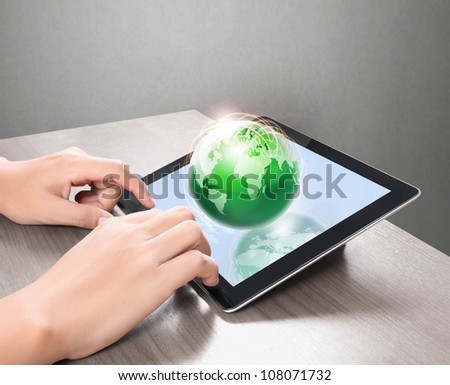 holding touch screen tablet and shows tablet in hand