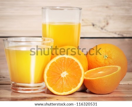 Orange juice and slices  on wood