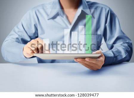 holding touch screen tablet with a graph