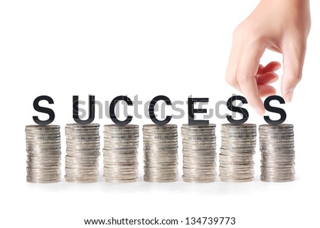 Hand and word Success isolated on gold coins white background