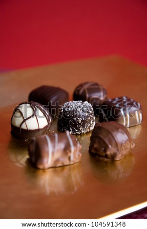Luxury Chocolates on gold serving dish, vertical