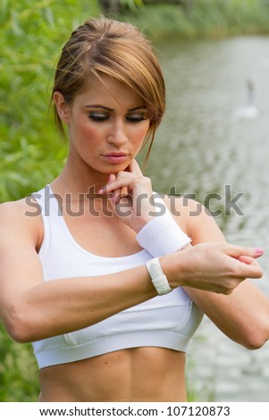 Fitness woman. woman checking heart rate after exercising. Concept sport and fitness