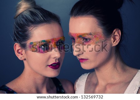 Creative colourful makeup on two fashion models