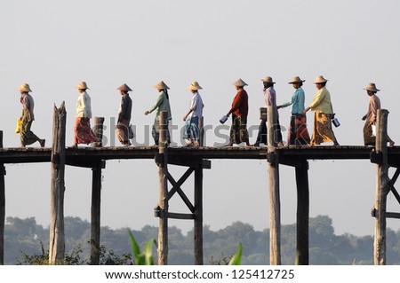 MANDALAY FEB 3 The villagers walking on U-Bein bridge Feb 3 2010 Mandalay Myanmar The bridge is the world longest teak bridge 1.2 km and built across the Taungthaman Lake MANDALAY FEB 3 The villagers walking on U-Bein bridge Feb 3 2010 Mandalay Myanmar The bridge is the world longest teak bridge 1.2 km and built across the Taungthaman Lake