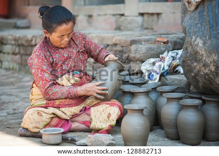 BHAKTAPUR, NEPAL - SEP 29 : Unidentified woman is molding the pot on September 29, 2012 in Bhaktapur. Bhaktapur is listed as a World Heritage by UNESCO for its rich culture, temples, and wood artwork.
