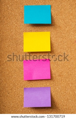 Colorful sticky notes on cork board