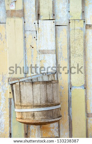 The bucket hung on wooden wall
