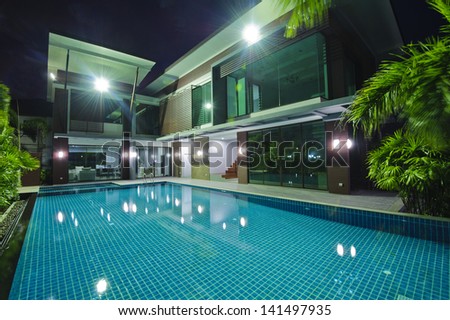 Modern House With Swimming Pool At Night