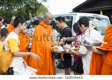 SANGKLABURI - OCT 18 : Thai people donated food to the monks in Sankaburi,Thailand on October 18, 2013. Sanklaburi is popular town for the tourism in Thailand.