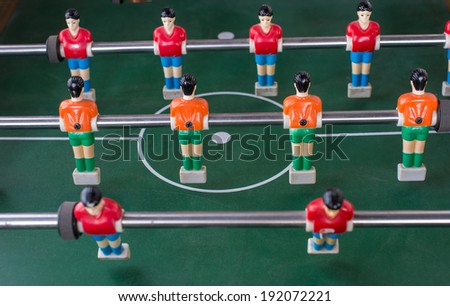 Table football game with red and orange players