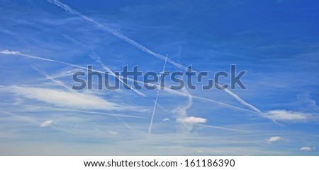 Aeroplane vapour trails showing busy flight path over the UK