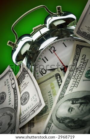 close up of the oldfashioned alarm clock and money