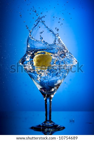 Close up view of the martini splash on blue
