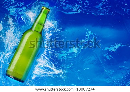 beer bottle being poured in a water