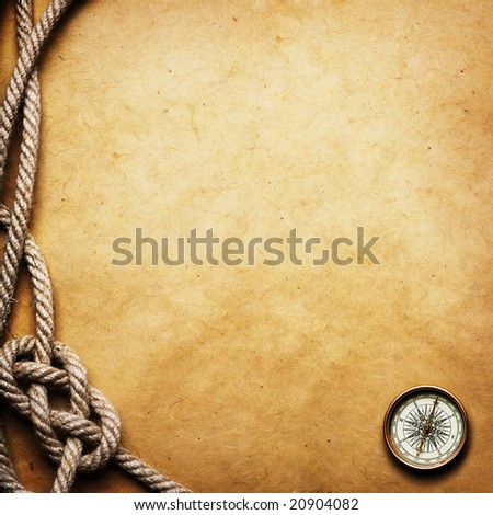 old compass and rope on grunge background