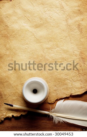 Inkwell and feather on a background of the empty form for the letter