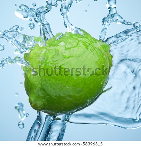 lime in spray of water. lime cucumber with splash on background