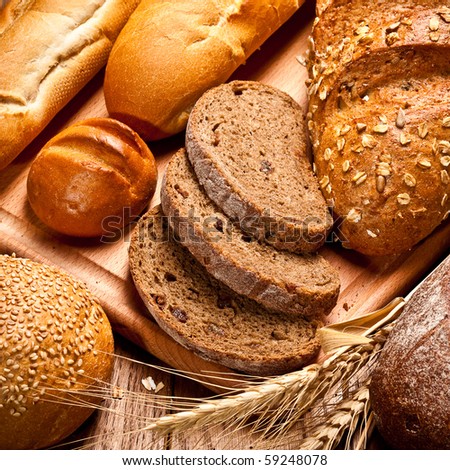 assortment of baked bread on wood table