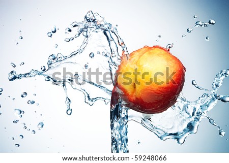 Peach in spray of water. Juicy peach with splash on background