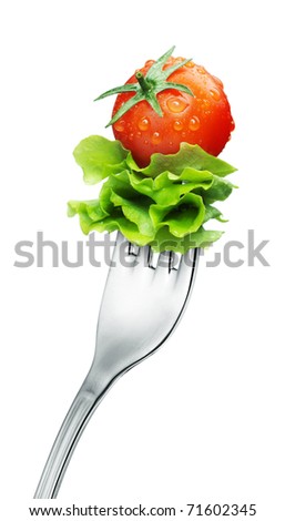fresh red tomato and salad on a fork Isolated fresh red tomato and salad on a fork Isolated