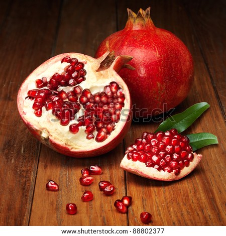 juicy pomegranate open on wood board