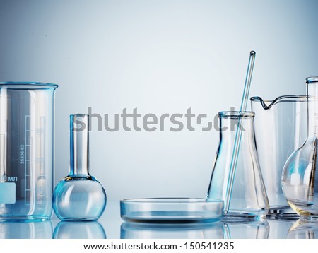 Laboratory glassware on color background