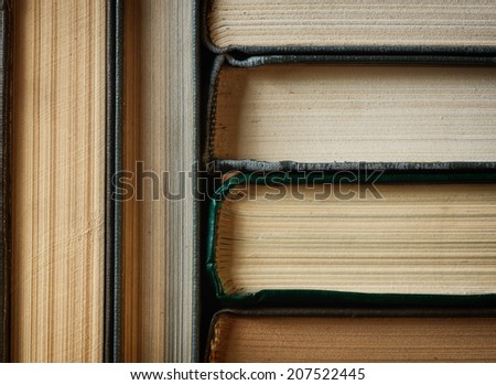 Concept background made of old books arranged in well-ordered close stacks
