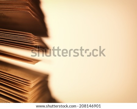 Close-up of the scattered pages of an old open book, concept of literature and knowledge, with copy space on beige background