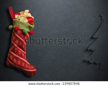 Christmas sock with red gift box on paper background