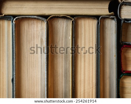 Concept background made of old books arranged in well-ordered close stacks