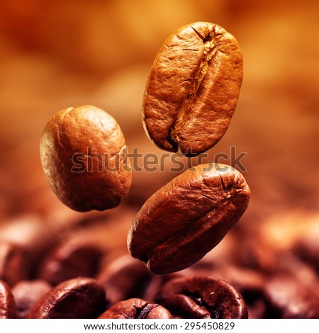 Closeup of coffee beans with focus on one. Filtered image: cool cross processed vintage effect.