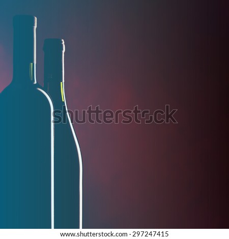 Bottle and glass of red wine on dark red background