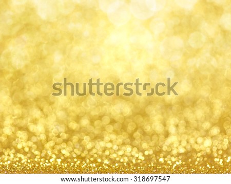 Gold Festive Christmas background. Abstract twinkled bright background with bokeh defocused golden lights