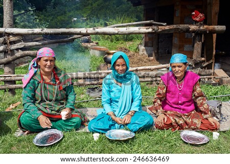 Naggar, INDIA - JULY 17: Indian woman waiting for a special food - prasadam. Prasad ritual food cooked and offered to God. July 17, 2013 in Naggar, Kullu Valley, Himachal Pradesh, India.